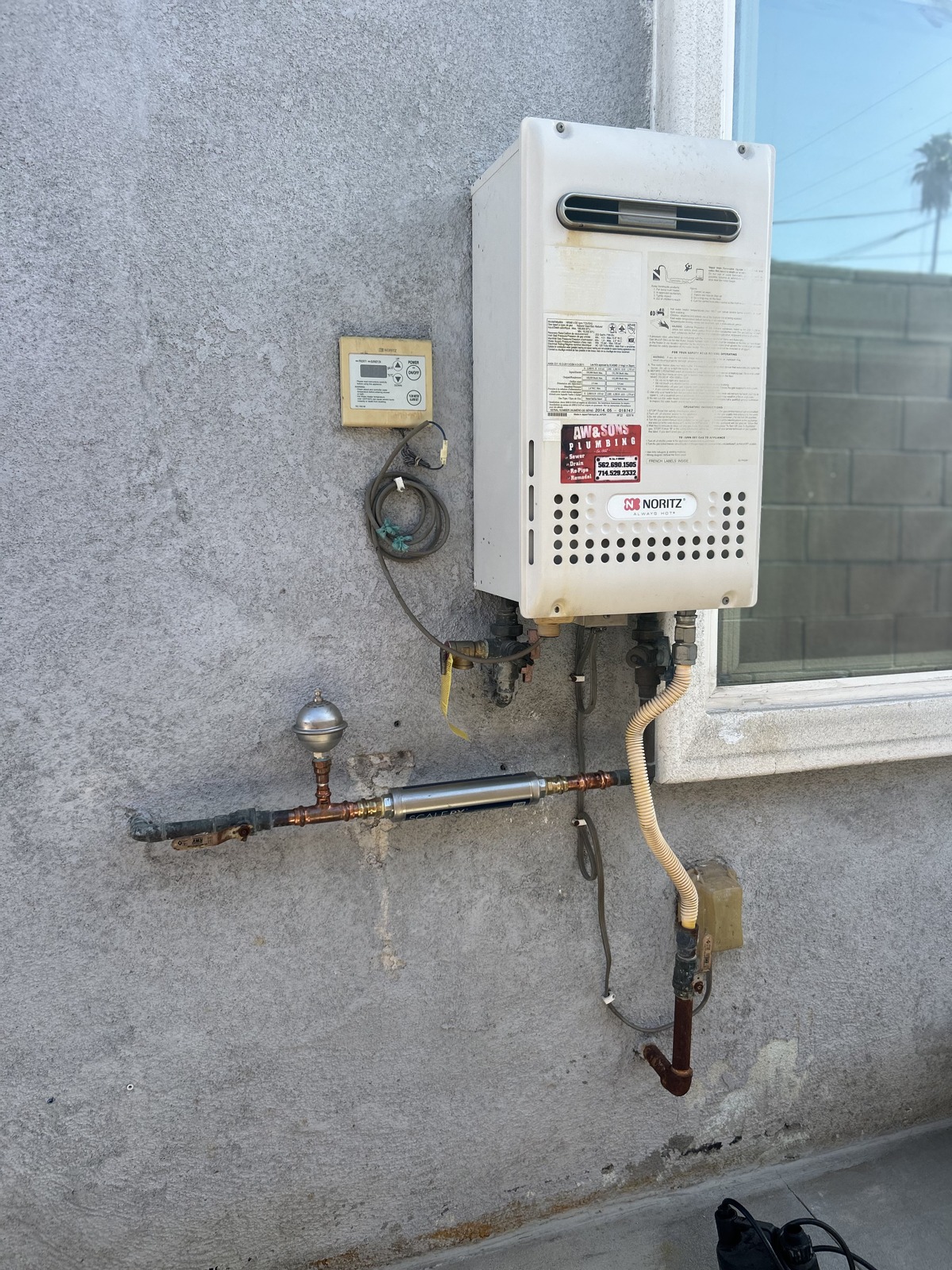 Finished tankless water heater installation with expansion tank and ScaleRX system