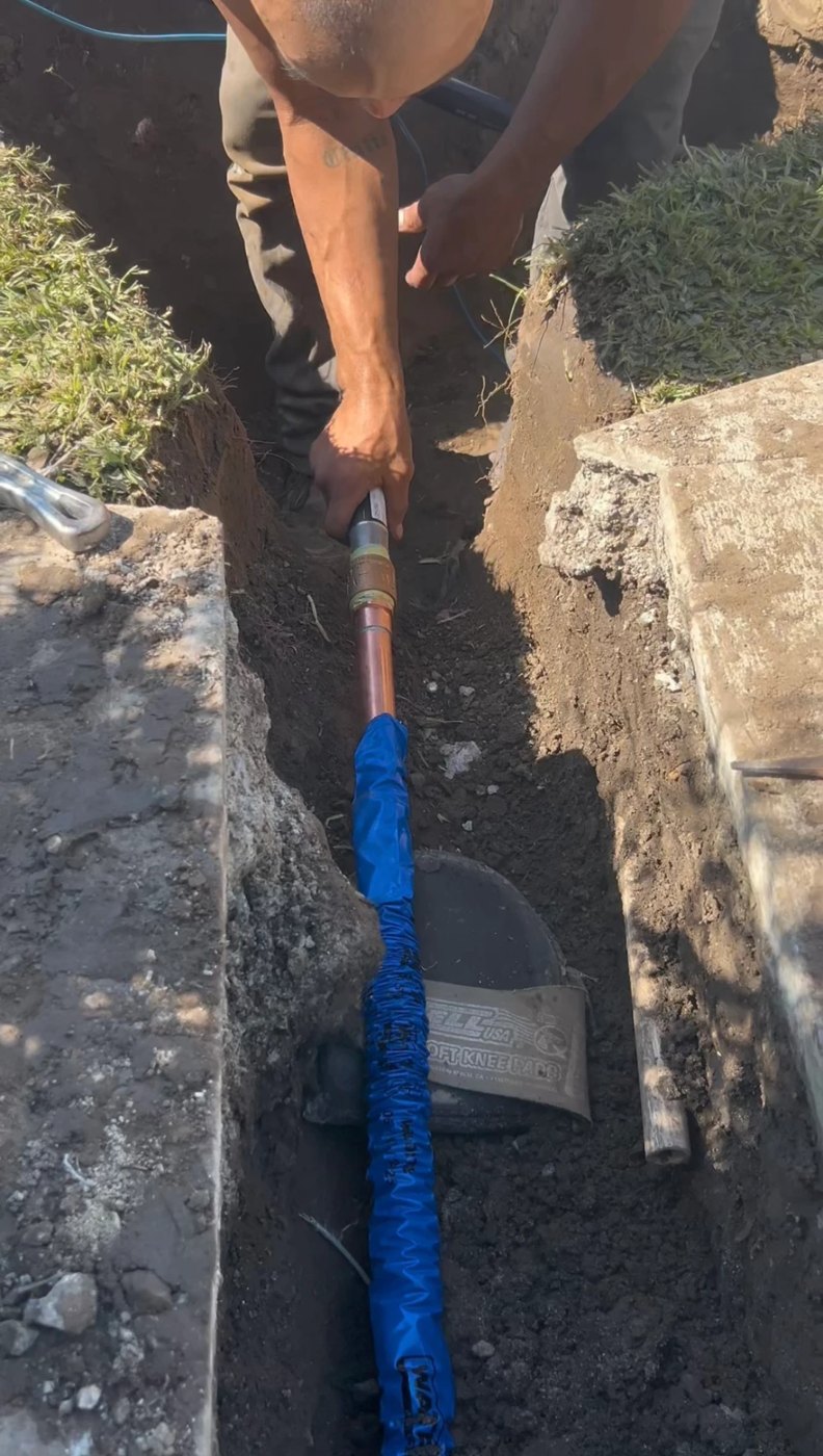 Close-up of the water line connection being worked on